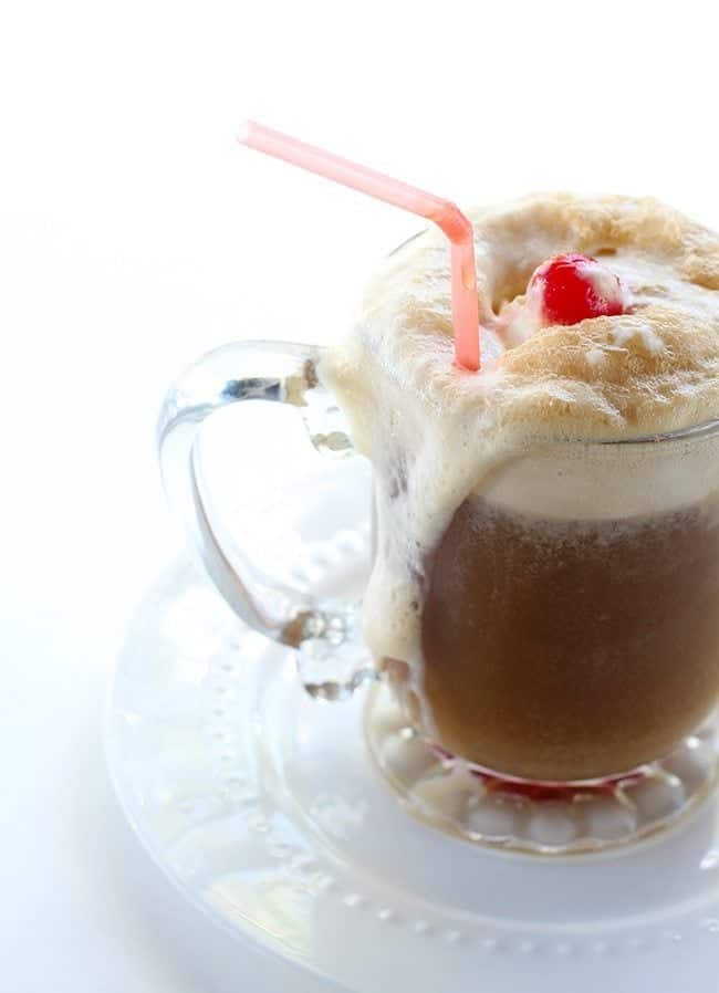 close up of Bourbon Root Beer Ice Cream Floats with whipped cream and cherry. 