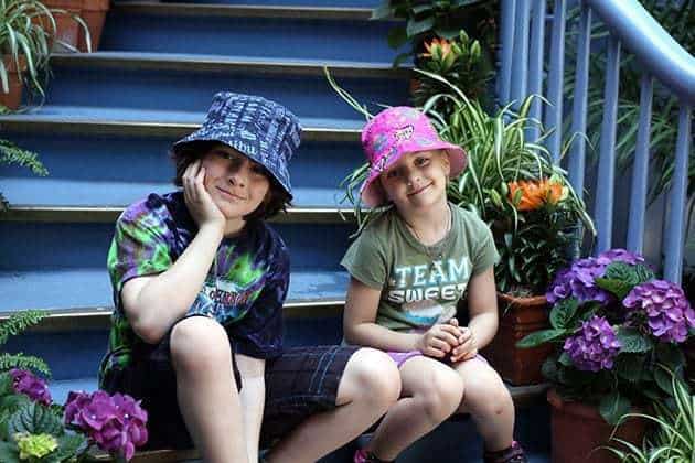 kids sitting in one of the stairs of Court des Anges at Disneyland