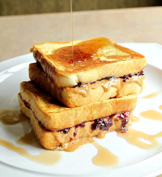 Syrup drizzled on top Peanut Butter & Jelly French Toast in a white plate