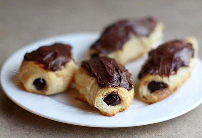 baked eclairs with chocolate pudding in the center and topped with chocolate icing