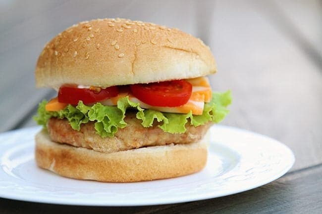 turkey burger with lettuce, cheese and slices of tomatoes