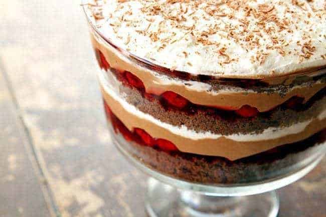 close up of Black Forest Cake Trifle with whipped cream on top and sprinkled with chocolate shreds