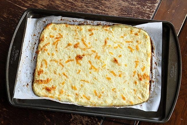 baked cauliflower mixture in a baking sheet with parchment paper