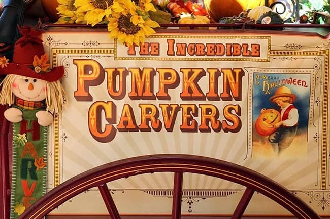 pumpkin carvers signage with cute scarecrow on the side