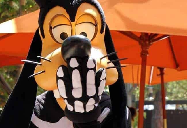 Disney Character Goofy in Halloween costume covering his mouth