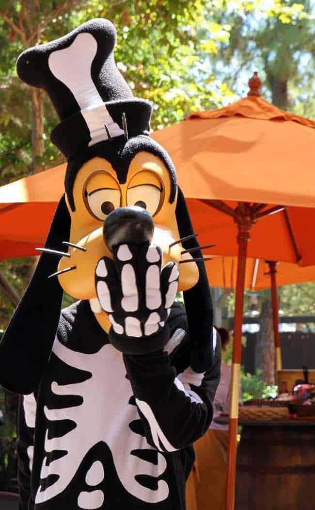 Disney Character Goofy in Halloween costume covering his mouth