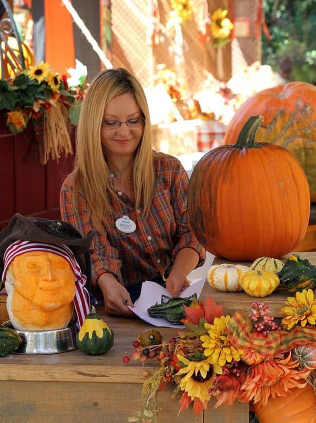 Disney staff demonstrating doing different crafts using pumpkins