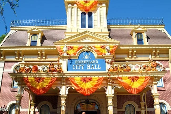 Disneyland City Hall with orange and yellow material draped and pumpkins everywhere