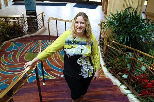 woman standing in the carpeted stair of the hotel