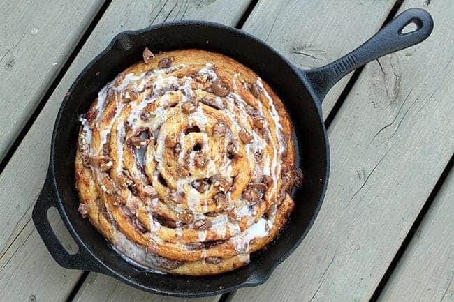 top down shot of Two Ingredient Giant Turtles Cinnamon Bun in skillet on wood background