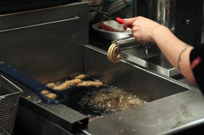 churros being made from the churro machine