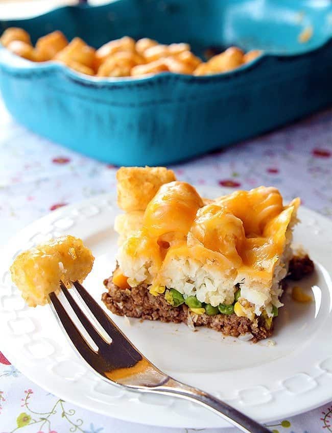 close up Tater Tots Shepherd's Pie and a stoneware casserole dish on background