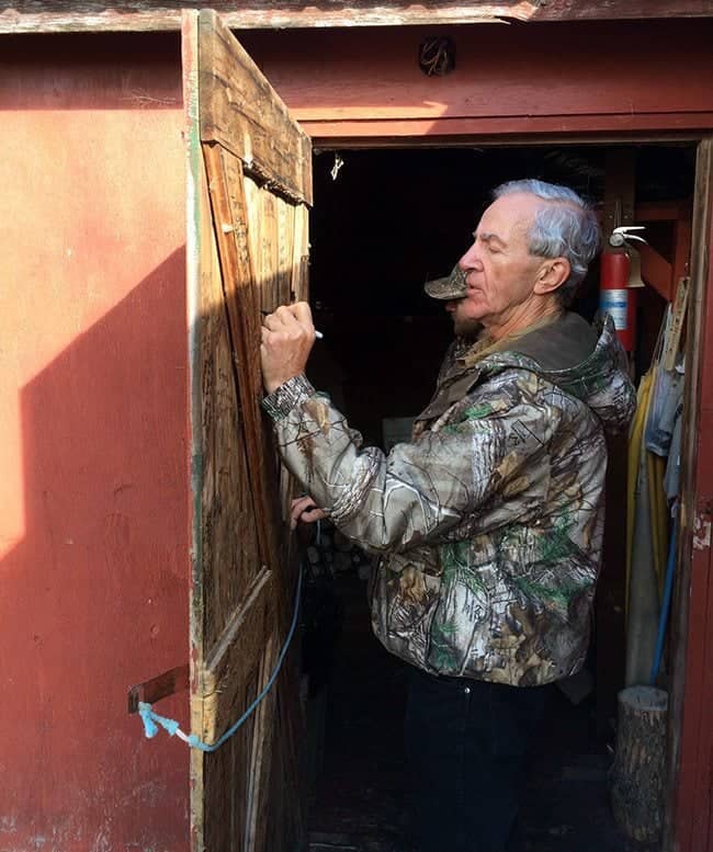 man writing in the wooden door