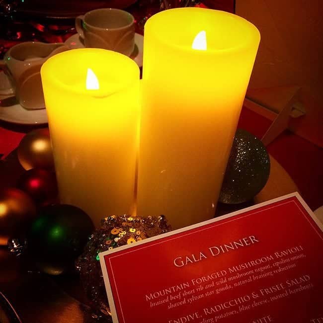 two large candle lights with the Gala Dinner card