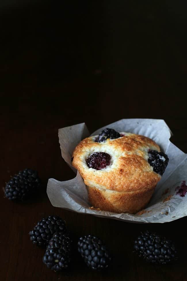 Lemon Blackberry Muffins with Muffin Liner on Dark Background with fresh Blackberry 