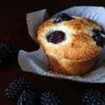Lemon Blackberry Muffins with Muffin Liner on Dark Background with fresh Blackberry