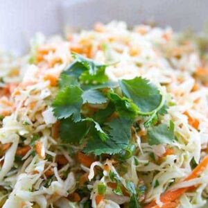 Simple Mexican Crispy Coleslaw with lime and garlic dressing garnish with parsley