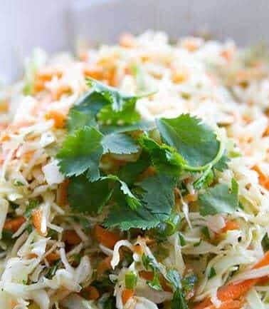 Simple Mexican Crispy Coleslaw with lime and garlic dressing garnish with parsley