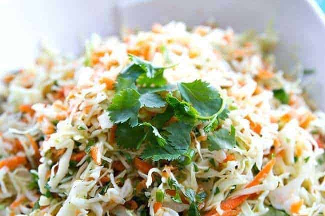 Simple Mexican Crispy Coleslaw with lime and garlic dressing garnish with parsley