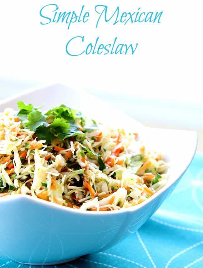 Mexican Coleslaw with lime and garlic dressing garnish with parsley in a Blue Pyrex bowl
