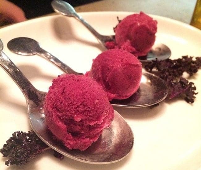 three large spoons with Concord grape sorbet