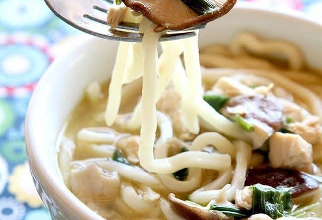 close up of noodles and mushroom in a fork from Chicken Mushroom Udon Noodle Soup