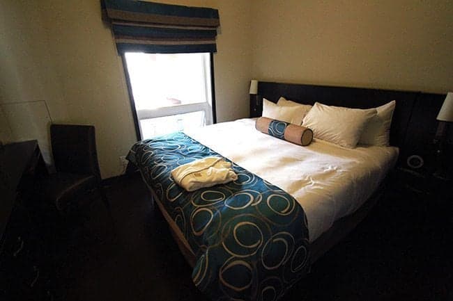 bed near the window with white pillows