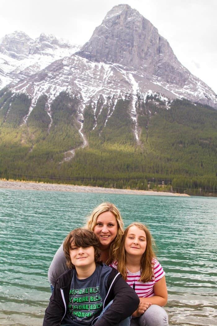 family picture with mother and kids with the view of mountain and ocean water