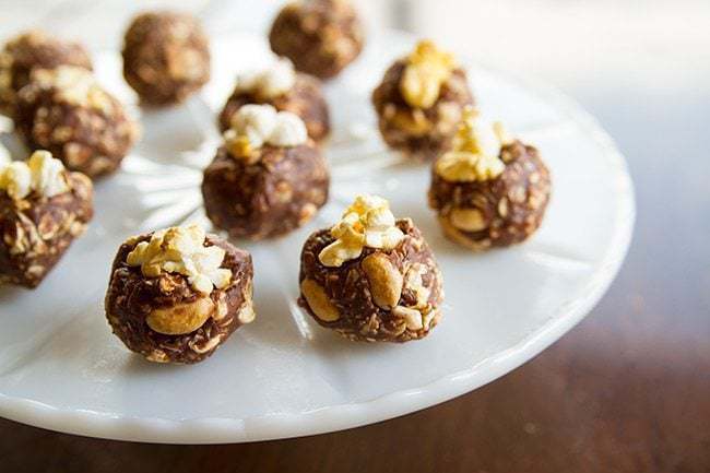 Close up of Peanut Butter Snack Bites with popcorn in a White Cake Holder