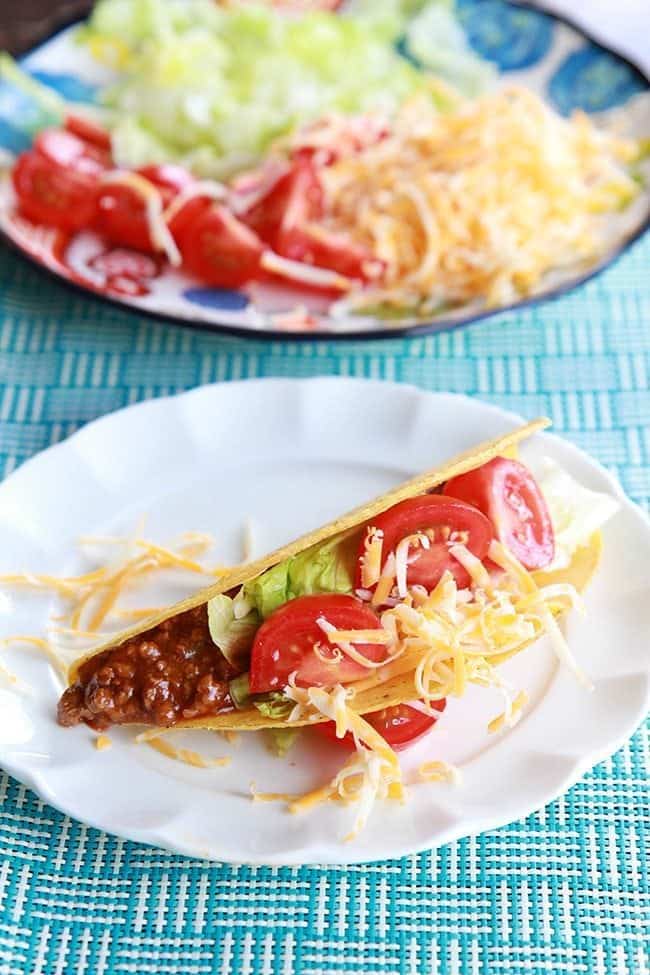 Classic Weeknight Tacos topped with shredded cheese