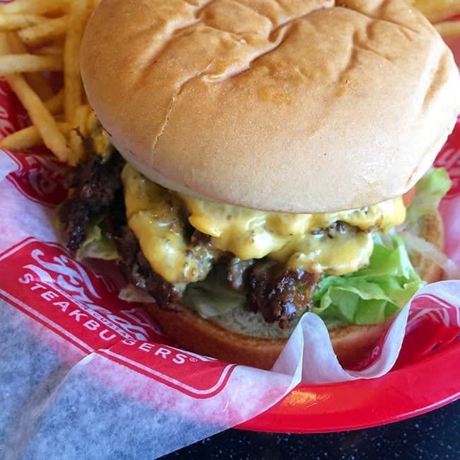 Frozen Custard and Steak burgers with compressed meat, some fries on side