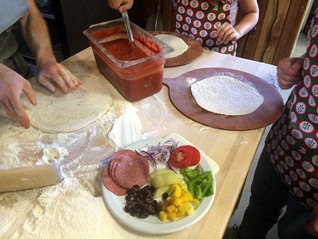 family making their pizza at Rocky Mountain Flatbread Company