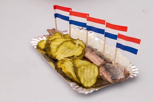 a serving of herring with mini Dutch flags