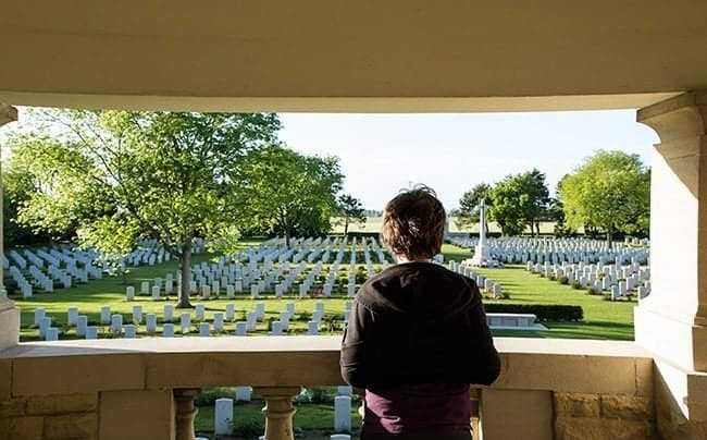 Boy looking at Bény-sur-Mer Canadian War Cemetery