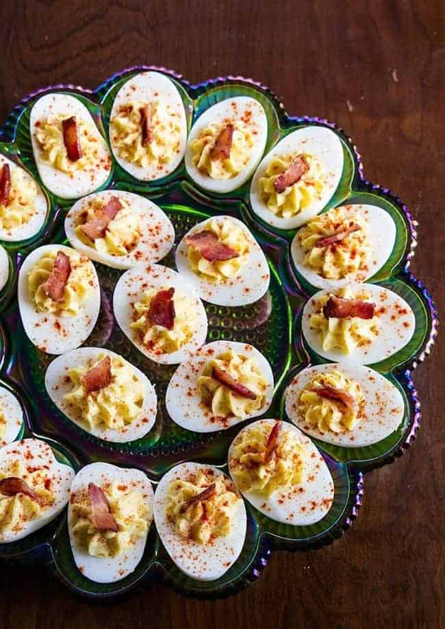 close up Bacon Deviled Eggs in a retro carnival glass deviled egg plate