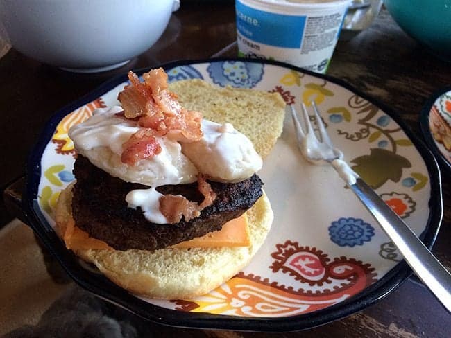 preparing the Perogy Burger with mayo and roasted garlic Aoili