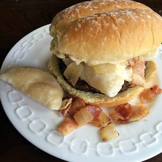 close up of Perogy Burger with Roasted Garlic Aoili in a white plate