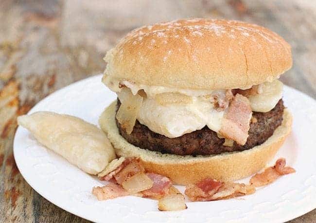 white plate with Magpie's Perogy Burger with Roasted Garlic Aoili