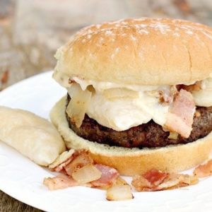 white plate with Magpie's Perogy Burger with Roasted Garlic Aoili