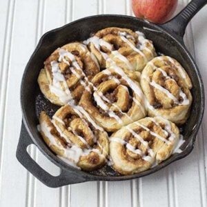 6 pieces Apple Pie Cinnamon Buns in Skillet on white background