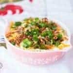 Crock Pot Mashed Potatoes topped with diced bacon, shredded cheese and chopped green onions