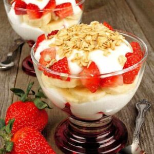 Toasted Oats Muesli sprinkled on top of yogurt with sliced strawberries