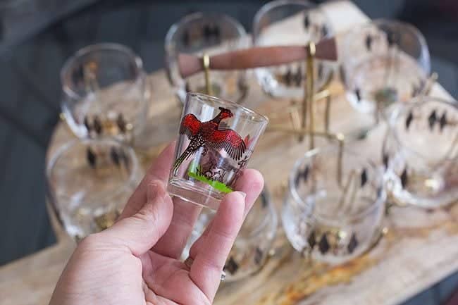 shot glass with pheasant and hunter pattern and a set of retro shot glasses on background