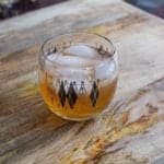 The Log Cabin Cocktail in a retro shot glass on a wood background