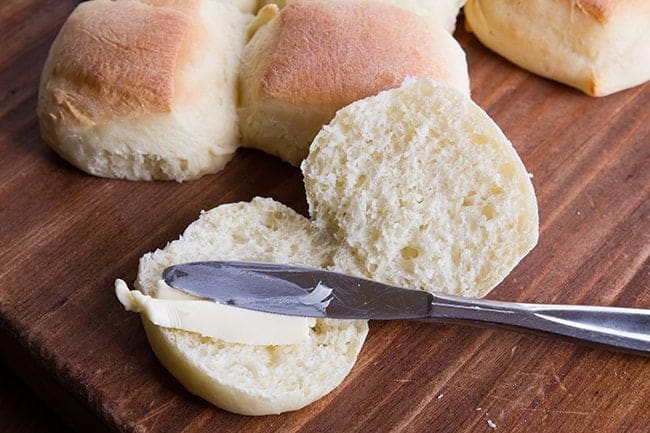 spreading honey butter into Sweet Dinner Rolls using spread knife