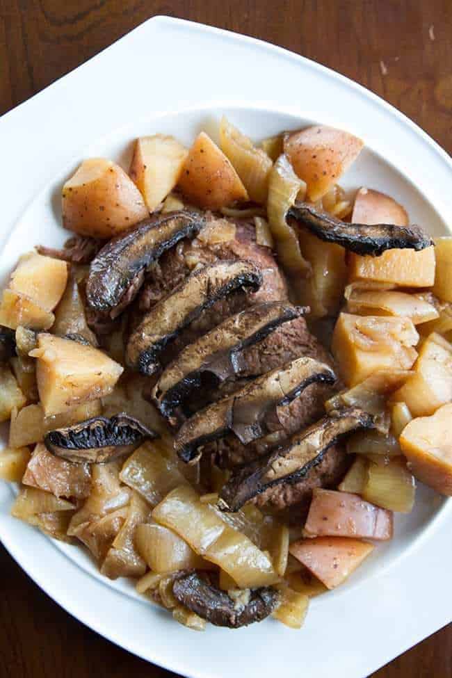 close up Flat Iron Steak with Portobello Mushrooms & Potatoes in a white plate