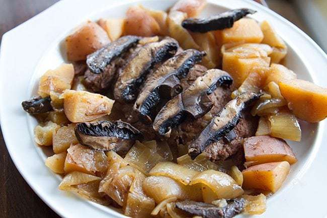 Crock Pot Flat Iron Steak with Portobello Mushrooms & Potatoes in a white plate