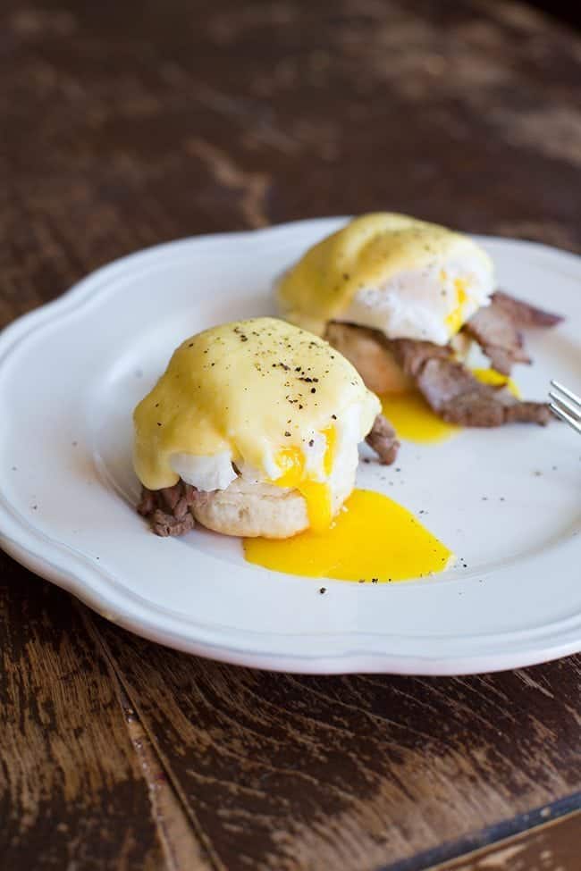 Buttermilk Biscuit with steak on one half, topped with a poached egg and Hollandaise Sauce