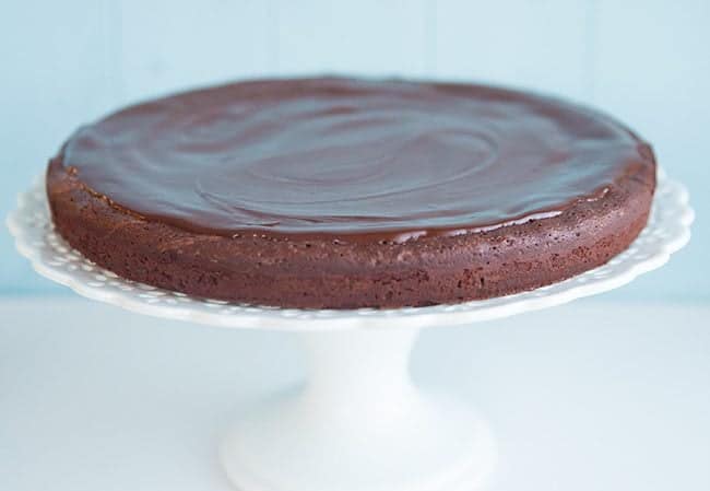 Flourless Chocolate Cake in a white cake stand