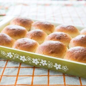 Close up of Old-Fashioned Southern Honey Butter Rolls in Pyrex baking pan